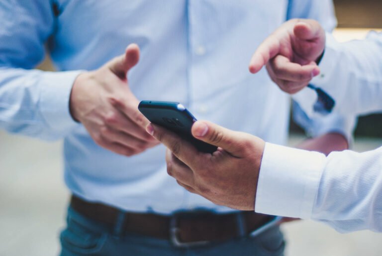 two men using a cell phone